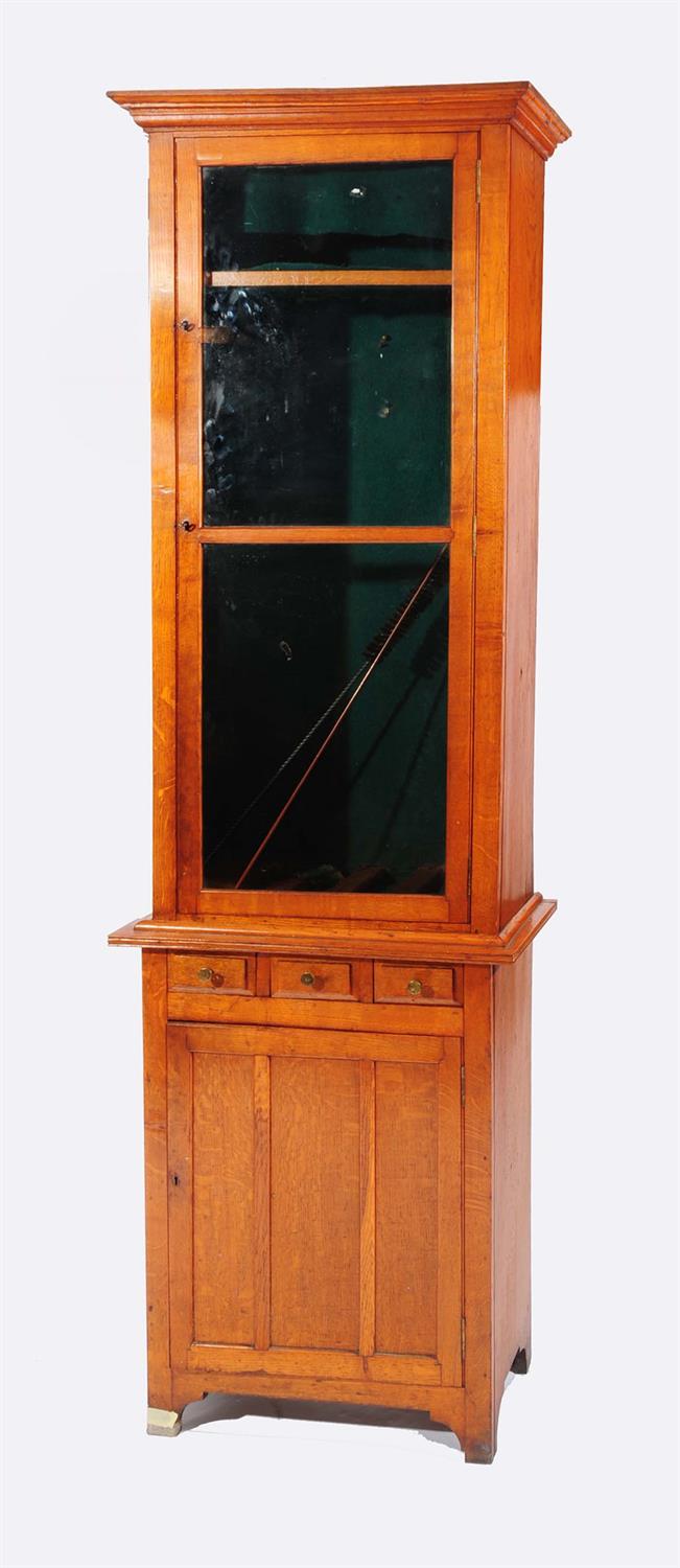Lot 164 - A LATE VICTORIAN OAK GUN CABINET IN TWO PARTS