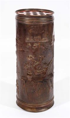 Lot 176 - AN EMBOSSED COPPER CYLINDRICAL STICK STAND decorated figures carousing in a tavern