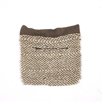 Lot 260 - A RARE BUSHMAN CHILD'S APRON with ostrich shell beadwork and hide border