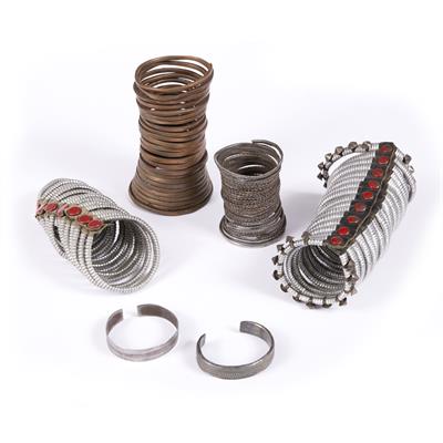 Lot 276 - A HIMBA WOMAN'S COPPER BANGLE; an Ova Himba men's long iron bracelet; two metal arm decorations; an