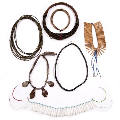 Lot 284 - A XHOSA NURSING NECKLACE; a Mason's coconut shell necklace; a Himba necklace; and four further