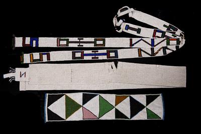 Lot 297 - A NDEBELE BEADWORK LONG STRIP decorated formal geometric design in colours on a white ground