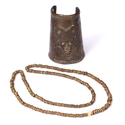 Lot 302 - A 20TH CENTURY BENIN BRONZE ARMLET with raised mask decoration