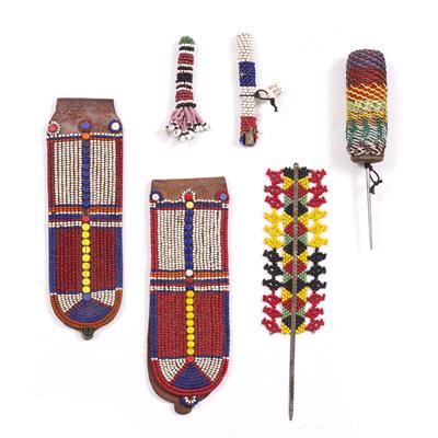 Lot 322 - A PAIR OF MASAI BEADED EAR FLAPS; a wired metal spike; a San beaded nose plug; a beaded spike; and a