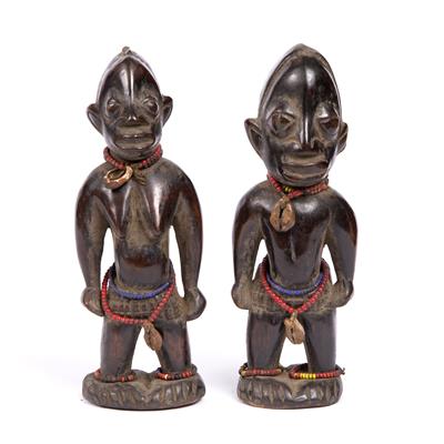 Lot 362 - A PAIR OF YORUBA IBEJI WOODEN FIGURES with beadwork and cowrie shell pendants