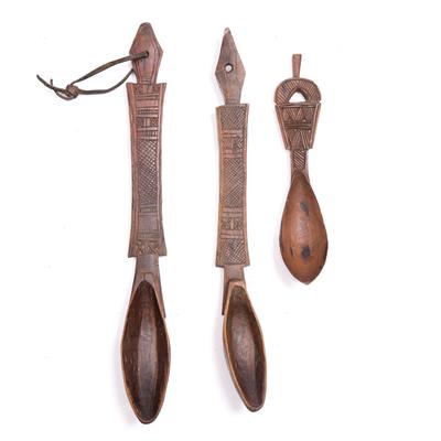 Lot 391 - A PAIR OF SOMALI BONI WOODEN LADLES with scratch work cross hatch and one smaller
