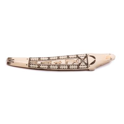 Lot 392 - AN INUIT CARVED WALRUS TUSK CRIBBAGE BOARD modelled as a seal with scrimshaw decoration