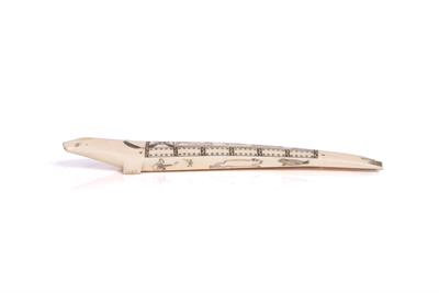 Lot 392 - AN INUIT CARVED WALRUS TUSK CRIBBAGE BOARD modelled as a seal with scrimshaw decoration