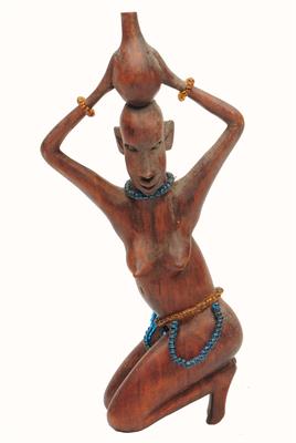 Lot 445 - A KAMBA KENYA CARVING of a kneeling woman holding a water gourd with bead ornaments