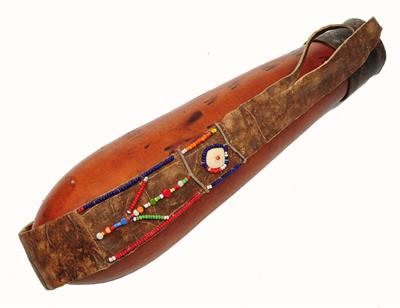 Lot 447 - A MASAI KENYA GOURD MILK CONTAINER with ostrich egg shell and beadwork decoration