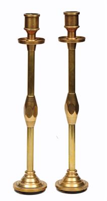 Lot 472 - A PAIR OF TRENCH ART BRASS TALL CANDLESTICKS with wax tray and circular stepped bases