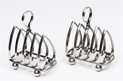 Lot 37 - A PAIR OF EARLY TO MID 20TH CENTURY HEAVY SILVER TOAST RACKS by Harrison Fisher & Co with marks for
