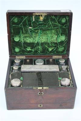 Lot 64 - A VICTORIAN ROSEWOOD AND BRASS BOUND LADIES DRESSING BOX the lifting lid opening to reveal a fitted
