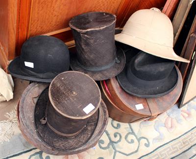 Lot 129 - A COLLECTION OF ANTIQUE HATS to include top hats together with two 19th century leather hat cases