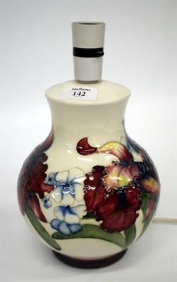 Lot 142 - A MOORCROFT TABLE LAMP the cream ground decorated with various flowers 21cm high