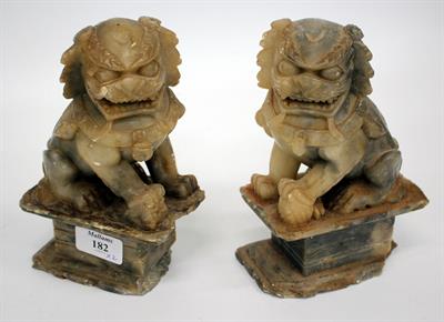 Lot 182 - A PAIR OF ORIENTAL SOAPSTONE TEMPLE DOGS mounted on rectangular plinth bases