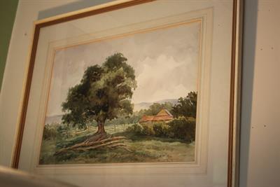 Lot 183 - MAUDE DARTE (19TH/20TH CENTURY ENGLISH SCHOOL) A COUNTRY VIEW with an oak tree with palm buildings