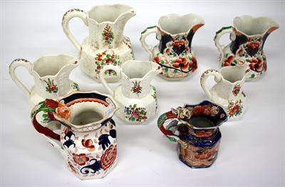 Lot 187 - A GRADUATED SET OF FOUR VICTORIAN JUGS with sprig decoration and sprays of flowers in coloured