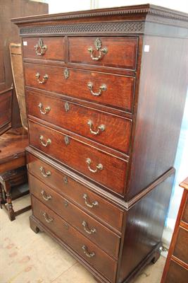 Lot 247 - A GEORGE III OAK TALLBOY with blind fretwork decoration to the cornice and mahogany cross banding to