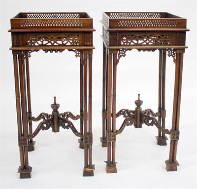 Lot 255 - A PAIR OF CHIPPENDALE STYLE URN STANDS with pierced galleries and cluster column supports 33.5cm