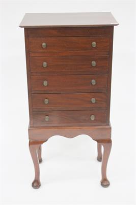 Lot 261 - A MAHOGANY MUSIC CABINET fitted five long drawers with fall fronts