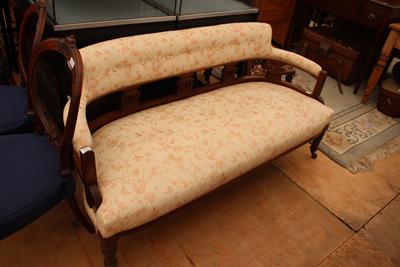 Lot 273 - A VICTORIAN MAHOGANY SMALL SOFA the button upholstered shaped back on pierced vase shaped splats