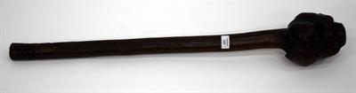 Lot 289 - A 19TH CENTURY IRISH BATTLE CLUB SHELALE with primitive carving of a face to the head of the club