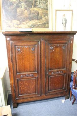 Lot 292 - AN ANTIQUE WALNUT FRENCH TWO DOOR ARMOIRE with carved decoration to the panelled doors and standing