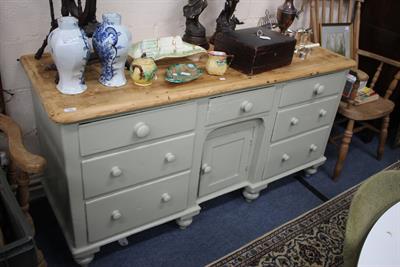Lot 294 - A PAINTED PINE DRESSER BASE the central panelled recessed cupboard surrounded by seven various