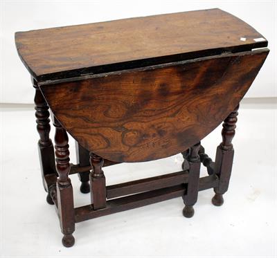 Lot 325A - AN 18TH CENTURY ELM DROP FLAP DINING TABLE standing on turned supports united by stretchers 83cm
