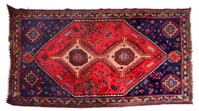 Lot 346 - AN ORIENTAL RED GROUND RUG with twin diamond motifs to the central field within a banded border