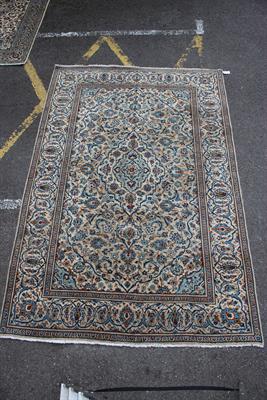 Lot 356 - A KASHAN CREAM GROUND RUG with flower decoration to the central field within an banded boarder