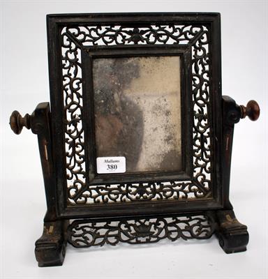 Lot 380 - A 19TH CENTURY ORIENTAL CARVED HARDWOOD SWING MIRROR converted from a table screen