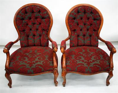 Lot 393 - A PAIR OF BUTTON UPHOLSTERED OPEN ARMCHAIRS with scrolling arms and standing on carved scrolling