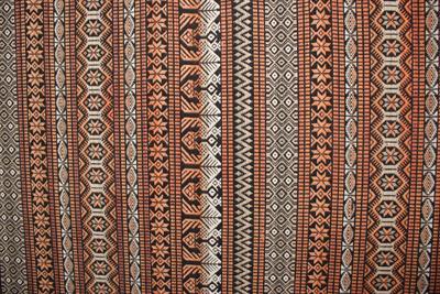 Lot 428 - A LARGE DECORATIVE AFRICAN TEXTILE WALL PANEL 256cm wide