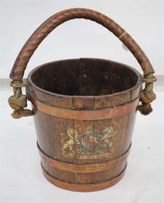 Lot 502 - A 19TH CENTURY COOPERED OAK FIRE BUCKET with rope and leather handle and Royal Coat of Arms