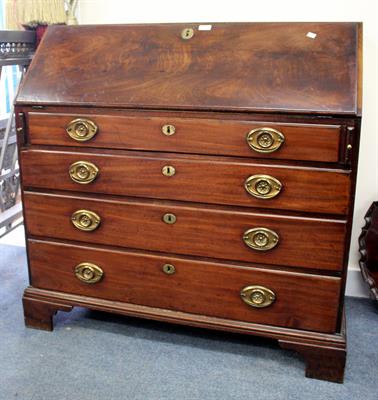 Lot 528 - A GEORGIAN MAHOGANY BUREAU the fall front opening to reveal pigeon holes and satinwood inlaid