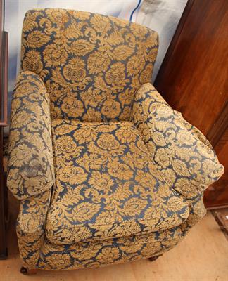 Lot 552 - AN EDWARDIAN UPHOLSTERED ARMCHAIR with mahogany legs and brass castors