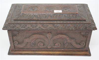 Lot 556 - A 19TH CENTURY CARVED OAK BOX with scrolling decoration