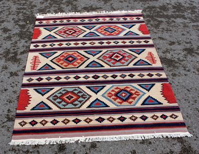 Lot 606 - A LATE 20TH CENTURY POLYCHROME TRIBAL KELIM decorated with stripes and motifs