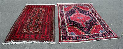 Lot 609 - A MIDDLE EASTERN RED GROUND RUG with a banded border