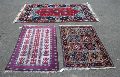 Lot 610 - A MIDDLE EASTERN RED AND BLUE GROUND RUG with multiple banded border