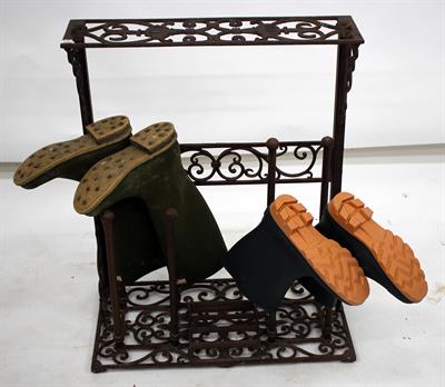 Lot 648 - A VICTORIAN STYLE CAST IRON BOOT RACK with pierced scrolling decoration together with a pair of