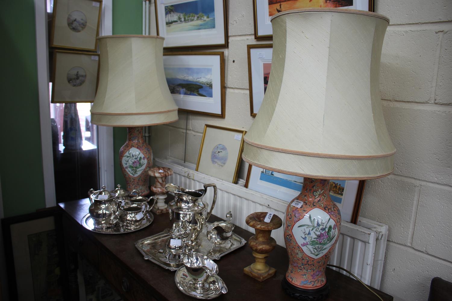 Lot 655 - A PAIR OF CHINESE PORCELAIN TABLE LAMPS decorated with scrolling foliage on a peach ground