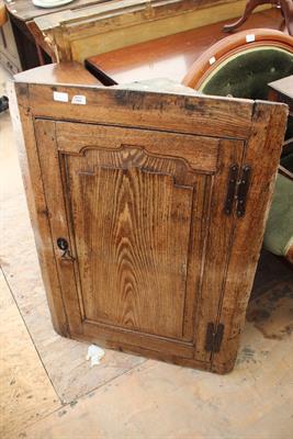 Lot 660 - A 18TH CENTURY OAK CORNER CUPBOARD with single panel door opening to reveal shelves within