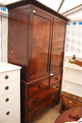 Lot 677 - AN EARLY TO MID 19TH CENTURY MAHOGANY LINEN PRESS the moulded pediment over twin panelled doors