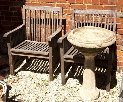 Lot 640 - A PAIR OF TEAK GARDEN ARMCHAIRS