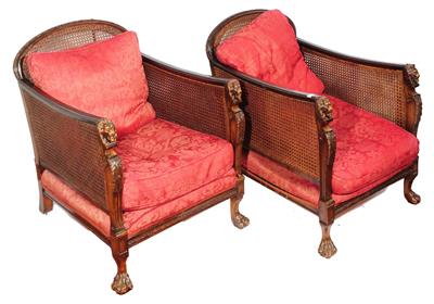 Lot 208 - A PAIR OF BERGERE LIBRARY ARMCHAIRS with cane sides and carved lions head column supports on claw