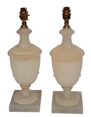Lot 218 - A PAIR OF ALABASTER URNS in neo-classical style of fluted form and carved basal acanthus foliage in