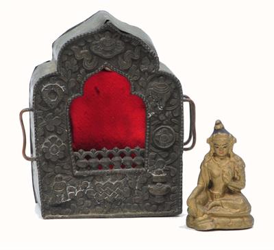 Lot 249 - A TIBETAN PORTABLE SILVER FACED SHRINE embossed with auspicious symbols containing a gold painted